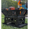 Ol Mate fire pit BBQ with rotisserie cooking over open flame in backyard setting