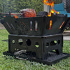 Ol'Mate portable camping fire pit cooking a roast on a rotisserie