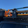 Top End Axe, Jack & Shovel Rack fitted to a 4WD roof rack, loaded with axe, high-lift jack and shovel